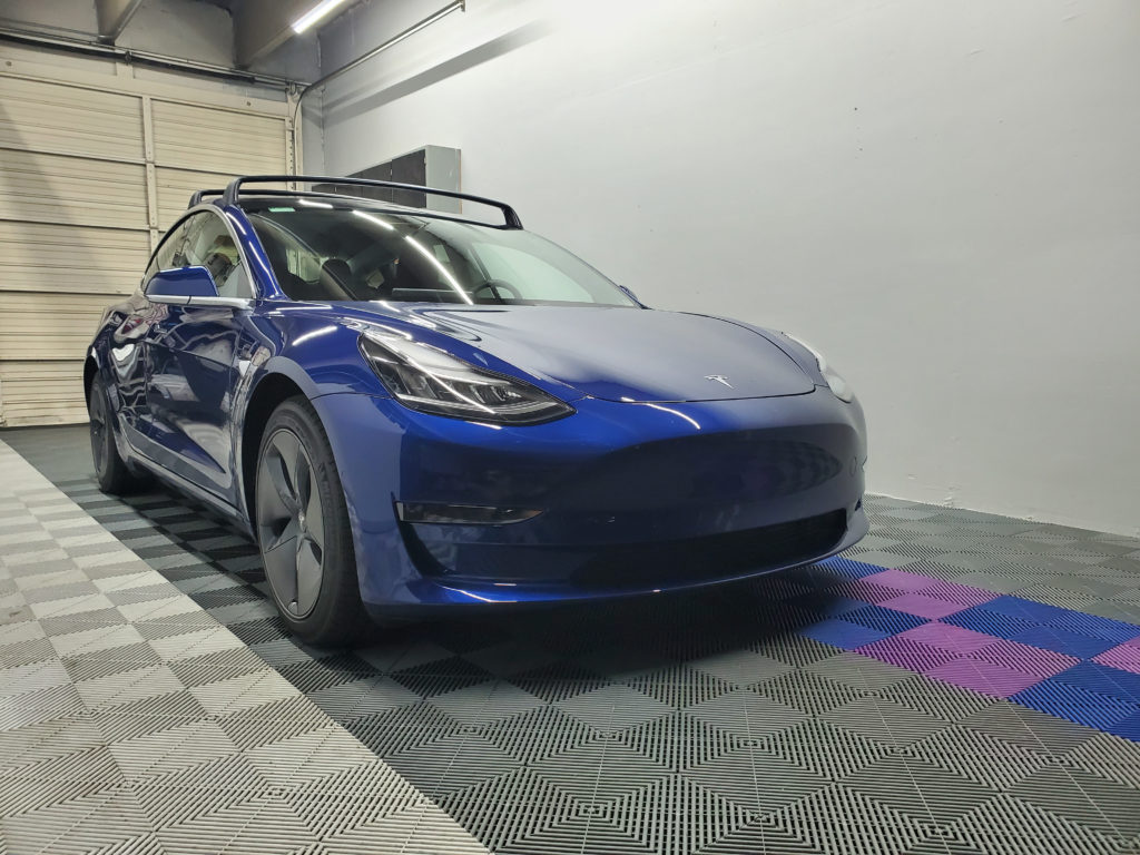shiny blue tesla model s car in garage
