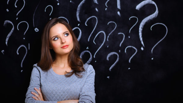 woman with question mark on a gray background